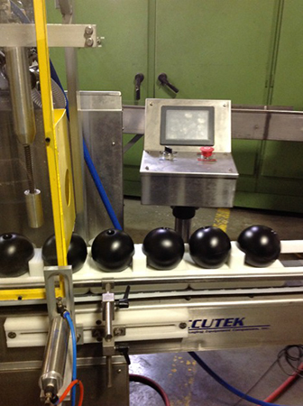 Hollow plastic shade balls on the production line at XavierC LLC manufacturing facility.